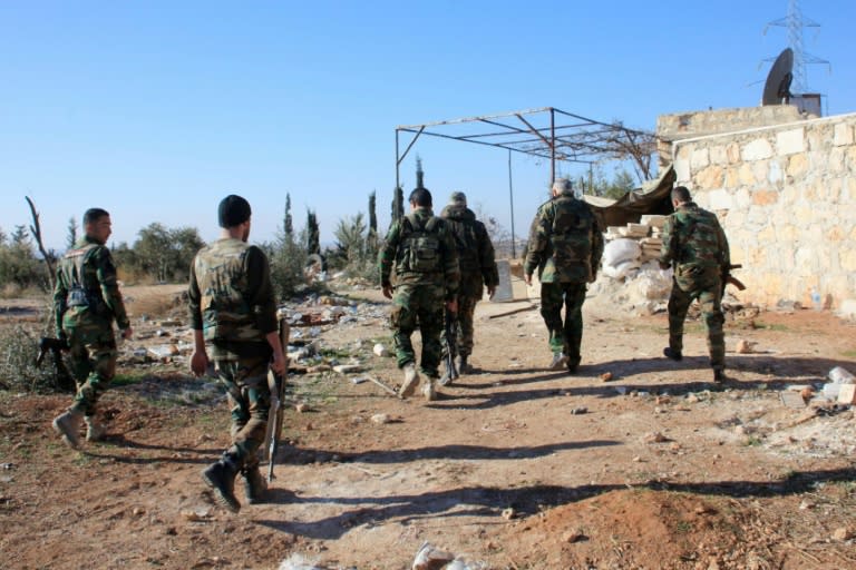 Syrian government forces patrol near Khan Tuman, south of the provincial capital Aleppo, after pro-regime forces recaptured several areas in the north from Islamist forces, including Al-Nusra Front