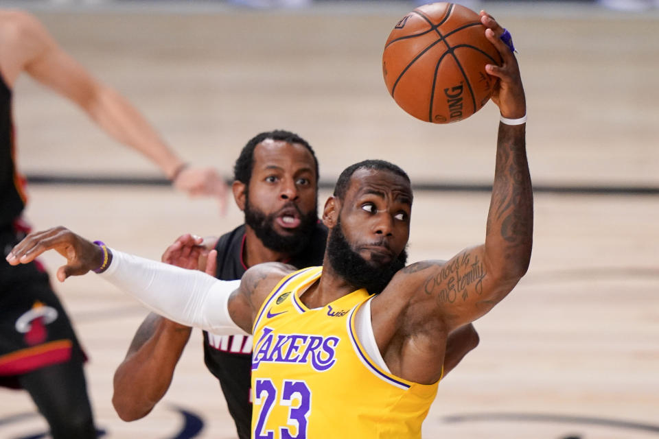 FILE - In this Tuesday, Oct. 6, 2020 file photo, Los Angeles Lakers forward LeBron James drives to the basket against the Miami Heat during the first half in Game 4 of basketball's NBA Finals in Lake Buena Vista, Fla. LeBron James has agreed to a contract extension with the Los Angeles Lakers. James' agency, Klutch Sports, confirmed the deal Wednesday, Dec. 2, 2020 during the first week of training camp for the NBA champions. (AP Photo/Mark J. Terrill, File)