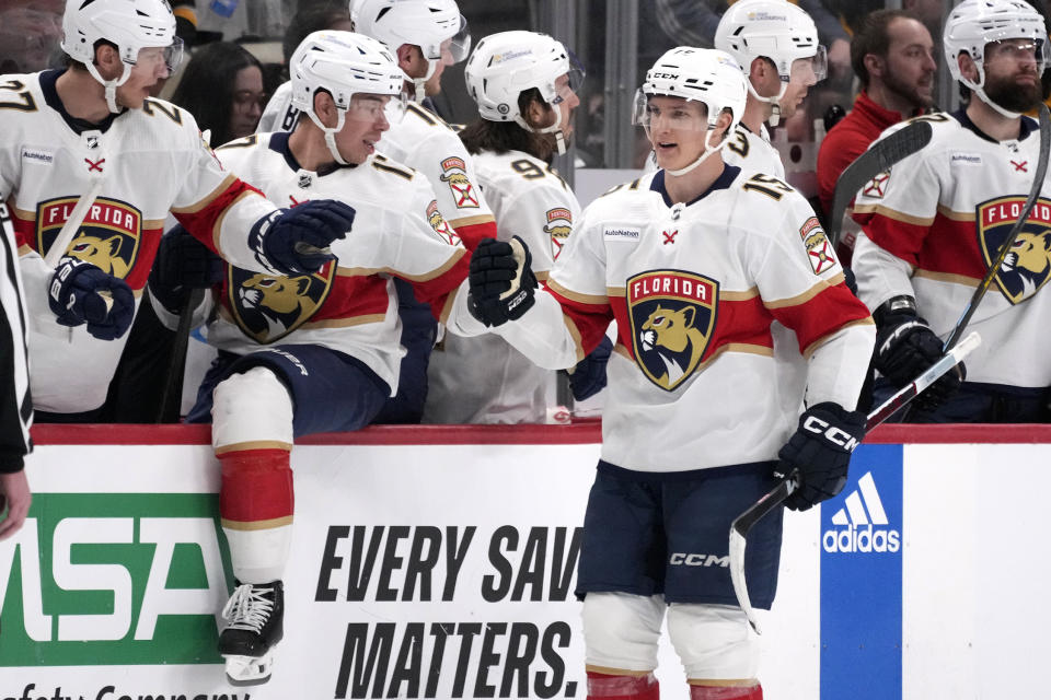 Florida Panthers' Anton Lundell (15) celebrates as he returns to the bench after scoring during the second period of an NHL hockey game against the Pittsburgh Penguins in Pittsburgh, Wednesday, Feb. 14, 2024. (AP Photo/Gene J. Puskar)