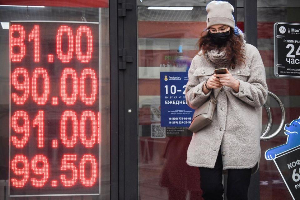 A woman walks past a currency exchange office in central Moscow on February 24, 2022 (AFP via Getty Images)