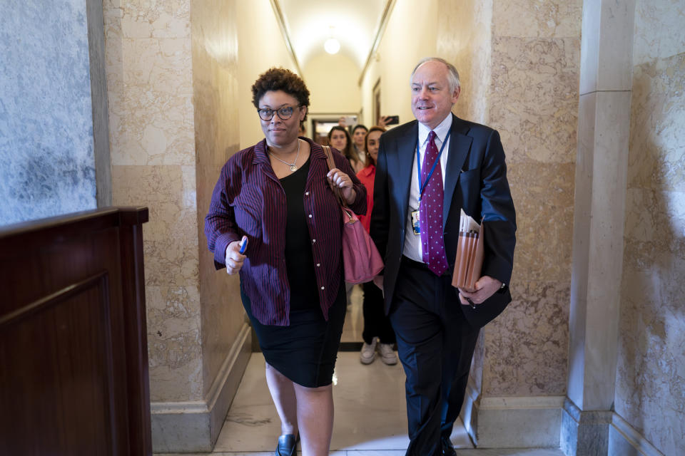 Shalanda Young, director of the Office of Management and Budget, left, and Steve Ricchetti, counselor to the president, the top negotiators for President Joe Biden on the debt limit crisis, head for the exit after talks with House Speaker Kevin McCarthy's emissaries came to an abrupt halt, at the Capitol in Washington, Friday, May 19, 2023. (AP Photo/J. Scott Applewhite)