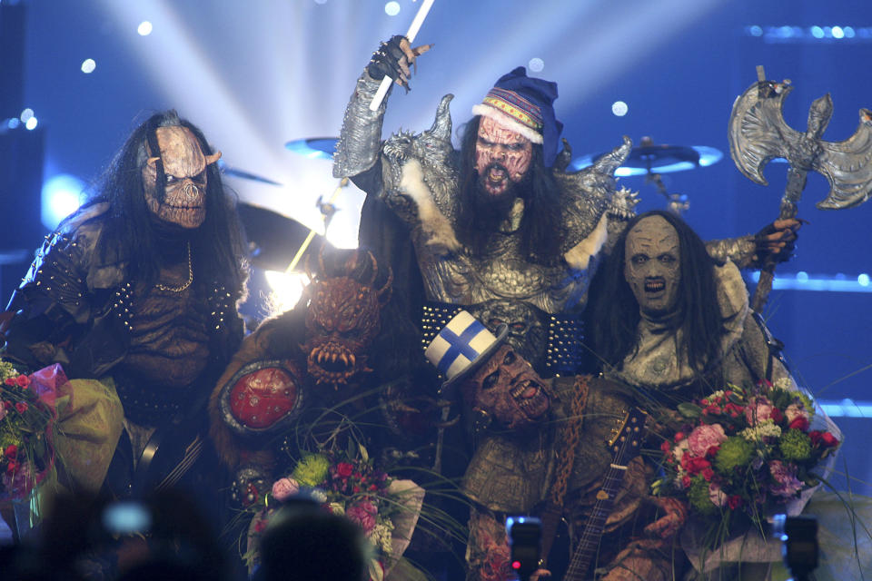 FILE - Finnish group Lordi celebrate after their victory in the Eurovision Song Contest, May 21, 2006, at the Indoor Olympic stadium in Athens, Greece. Since 1956, the Eurovision Song Contest has provided catchy tunes, cheesy pop and bombastic anthems - but also some eye-catching fashion. (AP Photo/Petros Giannakouris, File)