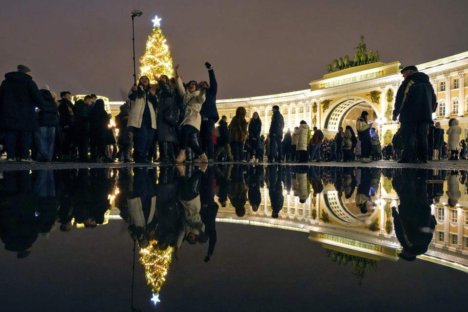 People take a selfie during New Year's celebrations in downtown St. Petersburg, Russia, early Sunday, Jan. 1, 2023. (AP Photo/Dmitri Lovetsky)