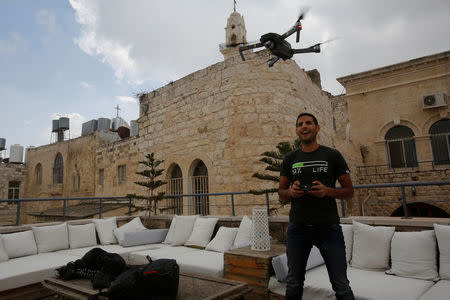 Nuseir Yassin flies his drone in the old city of the West Bank city of Bethlehem March 2, 2017. REUTERS/Mussa Qawasma