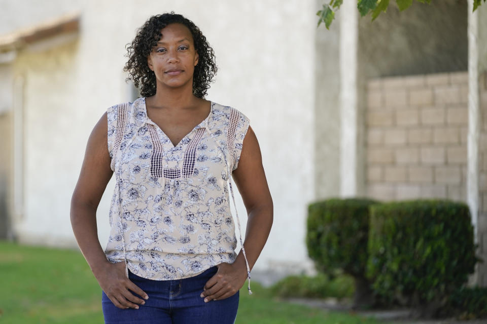 Brooke Aston Harper, whose children are 4 and 6, poses for a photo Monday, July 13, 2020, in San Clemente, Calif. She plans to do online distance learning with her 6-year-old when school starts in the fall. On one side are the parents saying, let kids be kids. They object to masks and social distancing at schools, arguing both could be detrimental to their children's well being, and want schools to reopen full-time. On the other side are parents and many teachers calling for things that would have been unimaginable pre-pandemic: part-time school, face coverings for all or full online curriculum. (AP Photo/Ashley Landis)