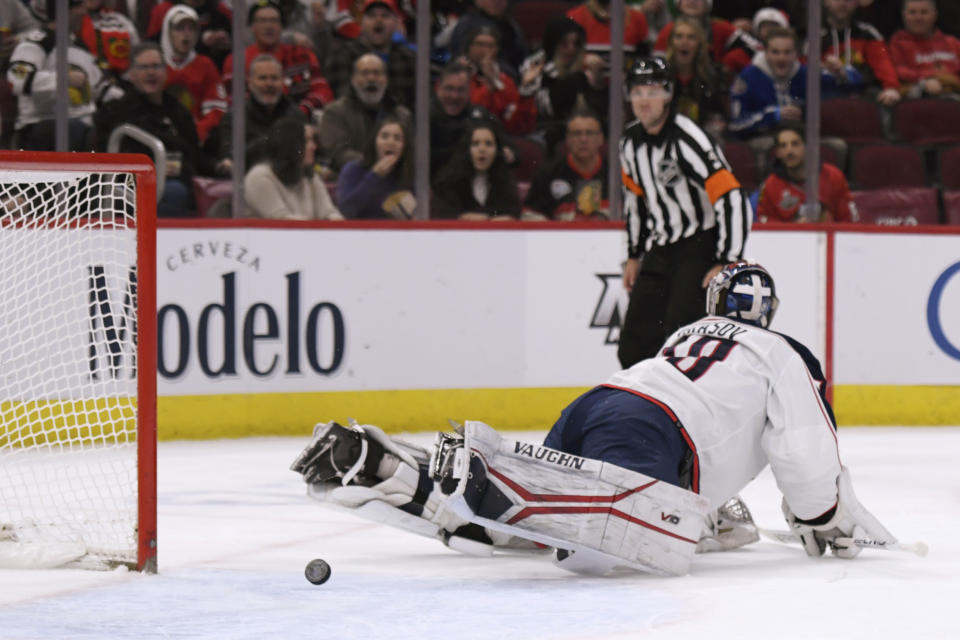Columbus Blue Jackets goalie Daniil Tarasov gives up a goal to Chicago Blackhawks' Max Domi during the first period of an NHL hockey game Friday, Dec. 23, 2022, in Chicago. (AP Photo/Paul Beaty)