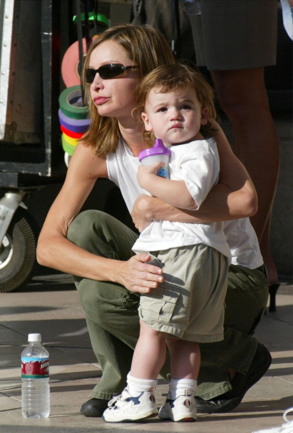 lista Flockhart holds her son, Liam, on the set of her boyfreind, actor Harrison Ford's upcoming movie, "Two Cops" on Rodeo Drive on September 17, 2002 in Beverly Hills, California.