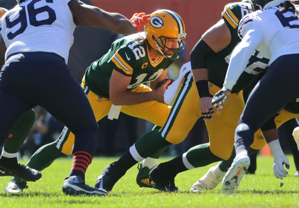 Aaron Rodgers plunges ahead to convert on fourth down during the second quarter against the Bears.