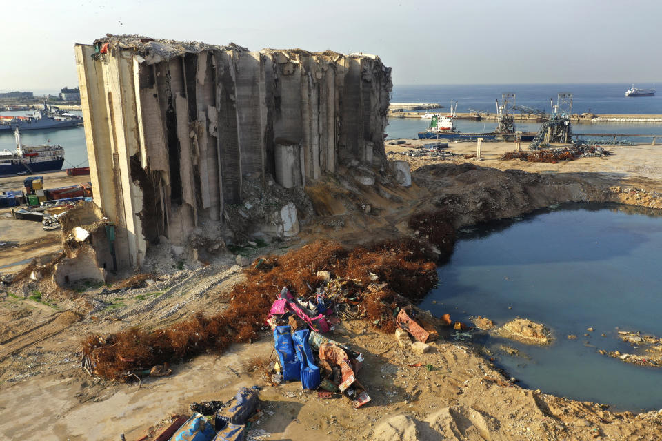 Rubble and debris remain around towering grain silos gutted in the massive August explosion at the Beirut port that claimed the lives of more than 200 people, in Beirut, Lebanon, Wednesday, Dec. 2, 2020. A heated debate is underway in Lebanon over the fate of the towering silos with some arguing the gutted silos could collapse at any moment, and must be demolished, while others call for the ruins to be preserved as a grim memorial. (AP Photo/Hussein Malla)