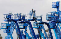 A man works on a crane at a factory of the Keihin industrial complex in Kawasaki, near Tokyo April 1, 2009. REUTERS/Kim Kyung-Hoon/File Photo