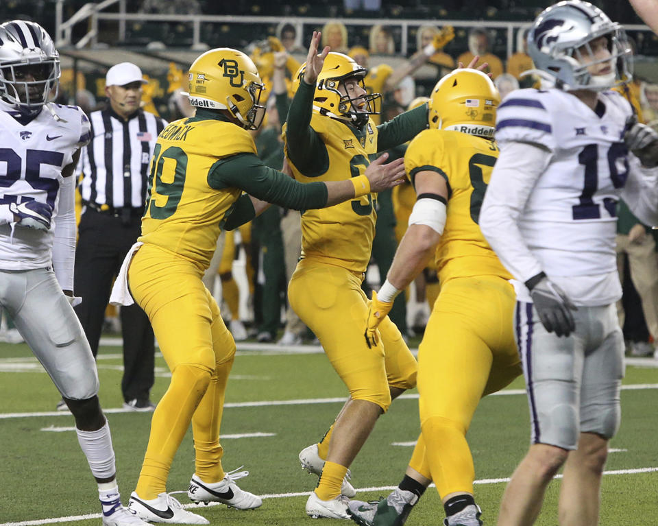 Baylor placekicker John Mayers (95), center, reacts as his teammates celebrate after his winning kick against Kansas State in the second half of an NCAA college football game, Saturday, Nov. 28, 2020, in Waco, Texas. (Jerry Larson/Waco Tribune-Herald via AP)