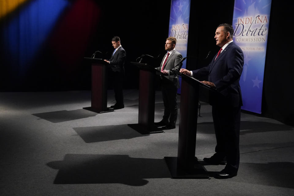 Democrat Thomas McDermott, right, speaks as Indiana Republican Sen. Todd Young, left, and Libertarian James Sceniak listen during a U.S. Senate debate Sunday, Oct. 16, 2022, in Indianapolis. (AP Photo/Darron Cummings, Pool)