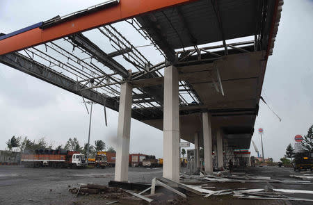 A damaged Indian Oil fuel station is pictured on a highway after cyclone Titli hit in Srikakulam district in Andhra Pradesh, India, October 11, 2018. REUTERS/Stringer