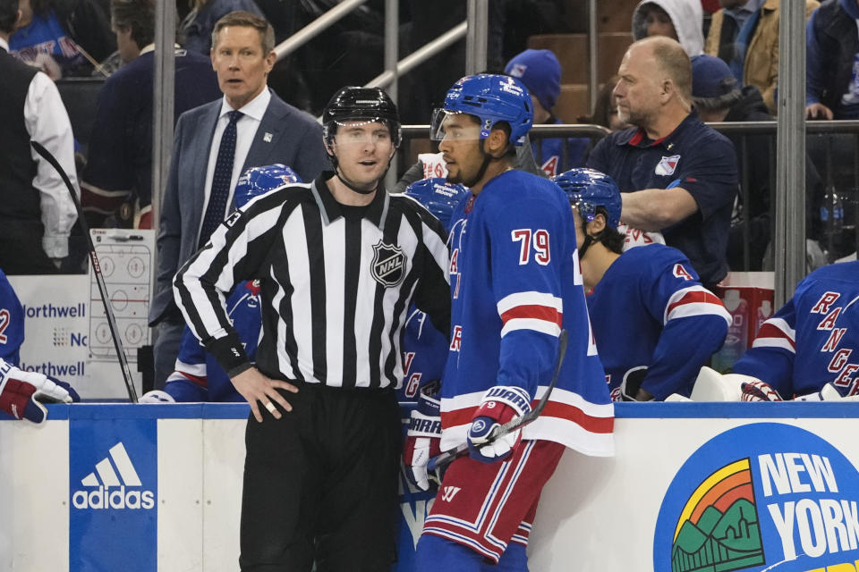 Linesman Kilian McNamara, left, talks to New York Rangers' K'Andre Miller (79) after Miller received a penalty during the first period of an NHL hockey game against the Los Angeles Kings, Sunday, Feb. 26, 2023, in New York. (AP Photo/Frank Franklin II)