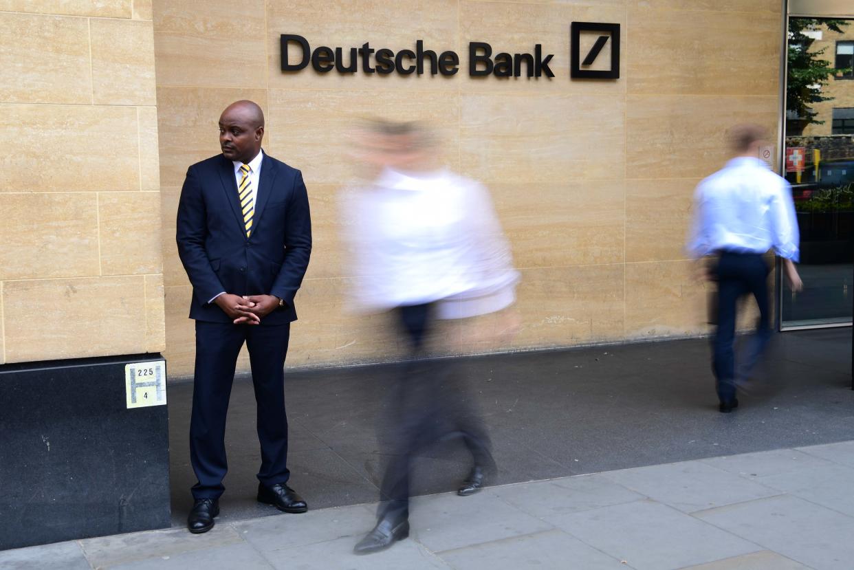 LONDON, ENGLAND - JULY 08: A security guard stands outside the Deutsche Bank building in central London as city workers walk past on July 8, 2019 in London, England. Deutsche Bank have started to make the first of a proposed 18,000 job cuts as part of a radical restructuring plan. (Photo by Leon Neal/Getty Images)