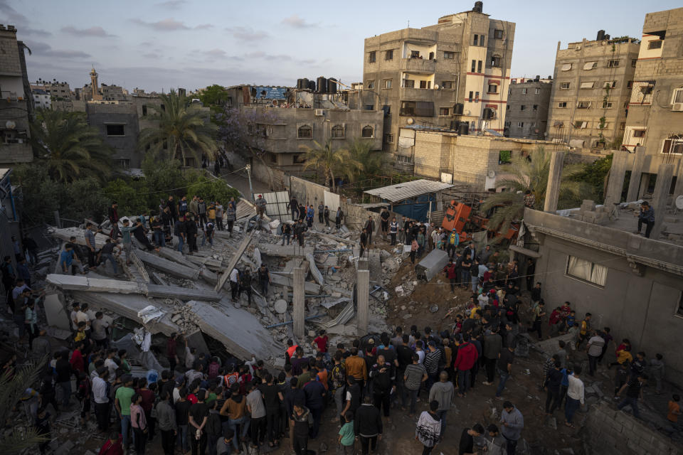 Palestinians inspect the rubble of Islamic Jihad member Zeyad Selmi's house after it was hit by an Israeli airstrike in Gaza City, Saturday, May 13, 2023. (AP Photo/Fatima Shbair)