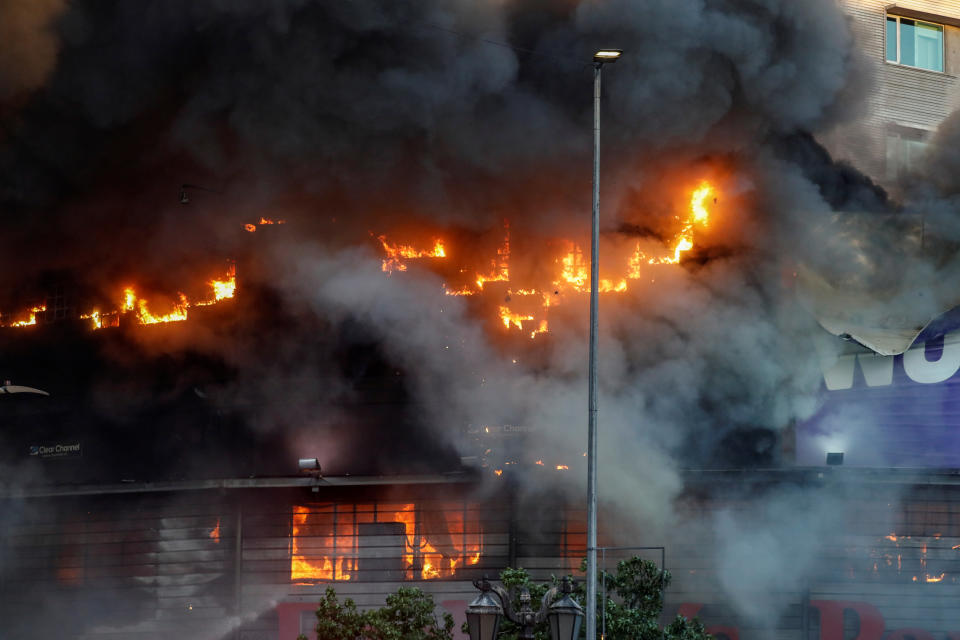 Flames and smoke emerge from a burning building during an anti-government protest in Santiago, Chile on Oct. 28, 2019. (Photo: Henry Romero/Reuters)