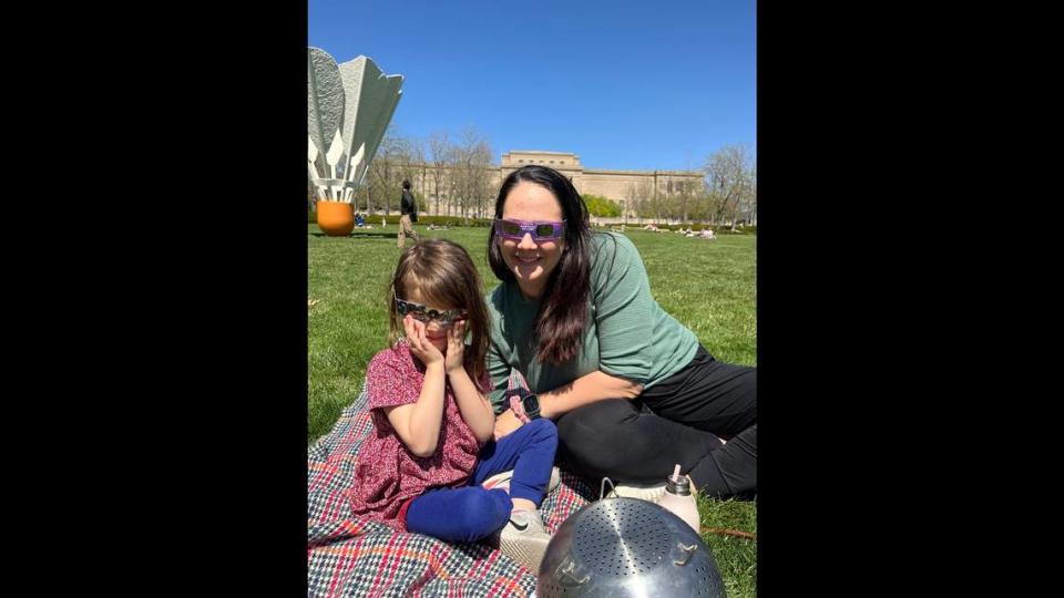 Lacy Fox, with her daughter, picked the middle of the lawn at the Nelson-Atkins Museum of Art to watch the eclipse pass through Kansas City Monday. Lacy’s daughter’s elementary school let kindergartners out of school early for the eclipse.