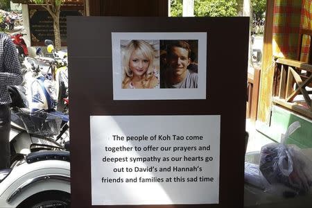 Pictures of killed British tourists David Miller and Hannah Witheridge and a message of support to their friends and families are displayed during special prayers at Koh Tao island September 18, 2014. REUTERS/Sitthipong Charoenjai