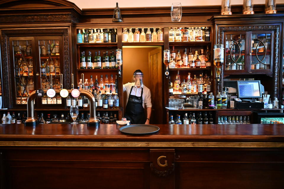 ABERDEEN, SCOTLAND - AUGUST 05: Kieth McKenzie wears a shielding face mask as he works in the pub The Grill in Union Street on August 5, 2020 in Aberdeen, Scotland. Scotland's First Minister Nicola Sturgeon acted swiftly and put Aberdeen back into lockdown after cases of Coronavirus in the city doubled in a day to 54. She ordered all indoor and outdoor hospitality venues to close by 5pm. (Photo by Jeff J Mitchell/Getty Images)