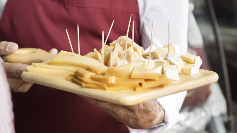 employee holding cheese samples