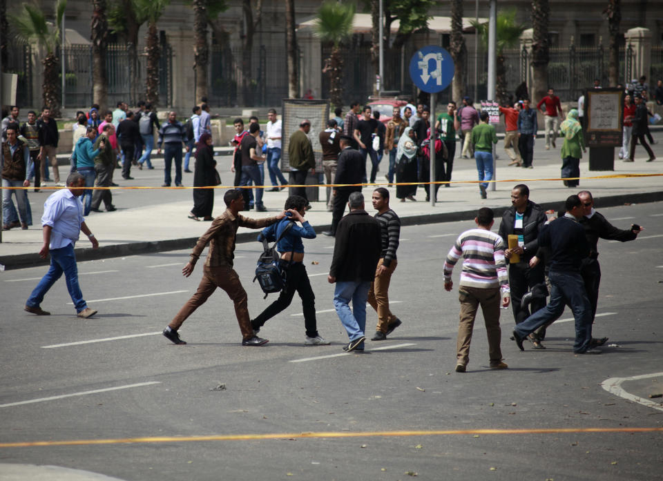 Egyptian security forces detain people at the scene after multiple explosions hit the area outside the main campus of Cairo University, killing at least two, in Giza, Egypt, Wednesday, April 2, 2014. The bombings targeted riot police routinely deployed at the location in anticipation of near-daily protests by students who support ousted Islamist President Mohammed Morsi and his Muslim Brotherhood group. (AP Photo/Sabry Khaled, El Shorouk Newspaper) EGYPT OUT
