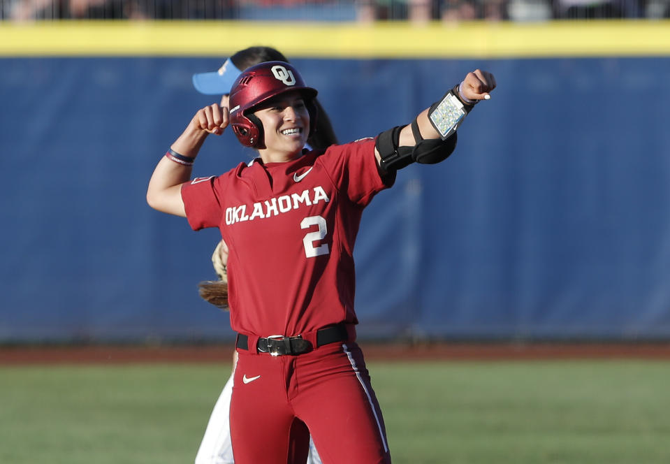 Oklahoma's Sydney Romero gestures after making it to second base against UCLA in the first inning of Game 2 of the best-of-three championship series in the NCAA softball Women's College World Series in Oklahoma City, Tuesday, June 4, 2019. (AP Photo/Alonzo Adams)