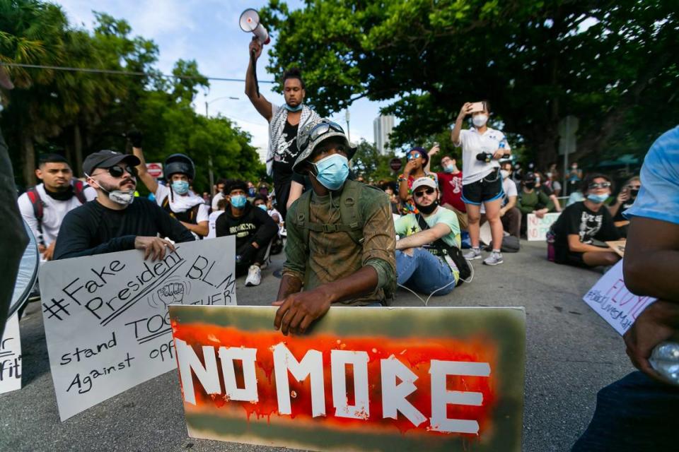 Activists stop to let others catchup as they march toward Overtown during a Justice for George Floyd protest in downtown Miami on Monday, June 1, 2020.