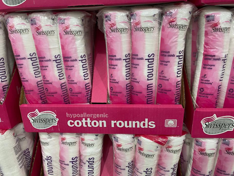 Packs of cotton rounds with pink packaging in display