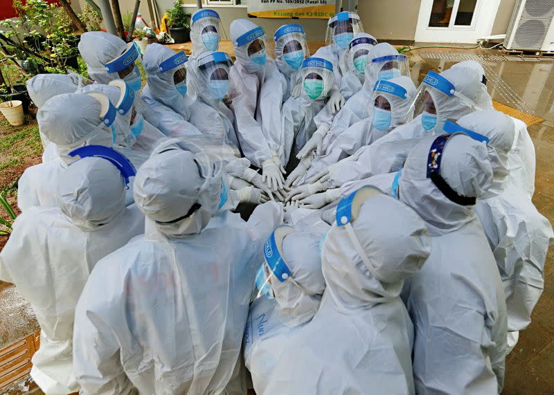 Healthcare workers prepare to treat patients at the emergency COVID-19 hospital in Athletes Village, Jakarta