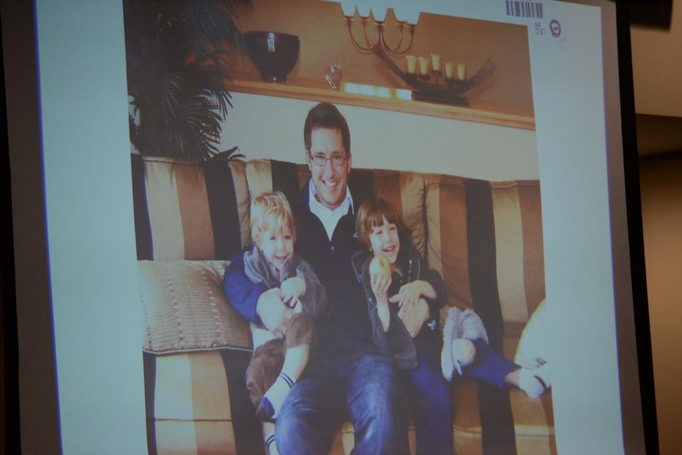 A photo of Dan Markel and his two sons is shown on the screen in the courtroom as his mother, Ruth Markel, gives her victim impact statement during sentencing for Sigfredo Garcia in 2019.