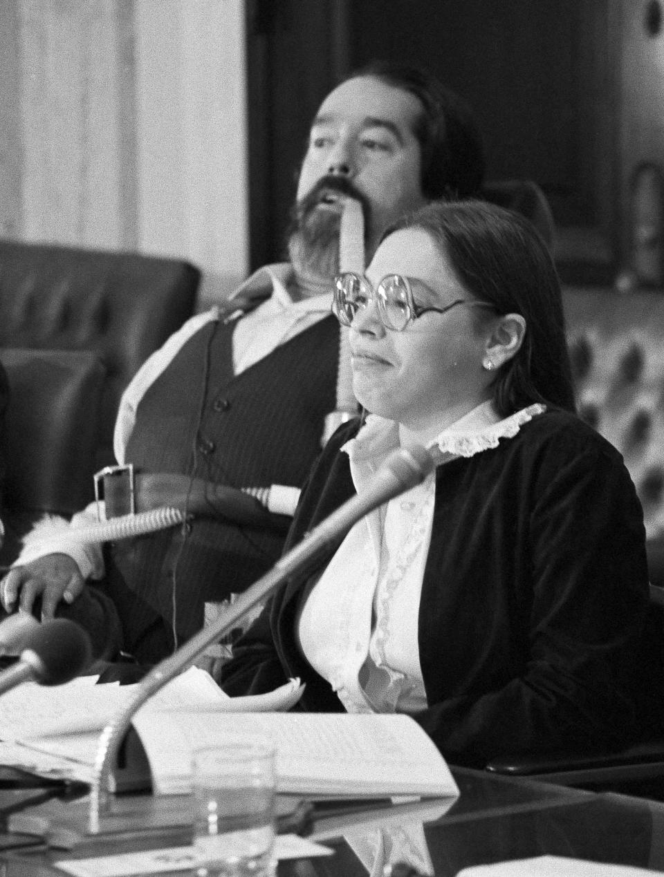 Judy Heumann, right, and Ed Roberts, left, director of the California State Department of Rehabilitation, take part in a news conference on Oct. 21, 1982 in Washington.