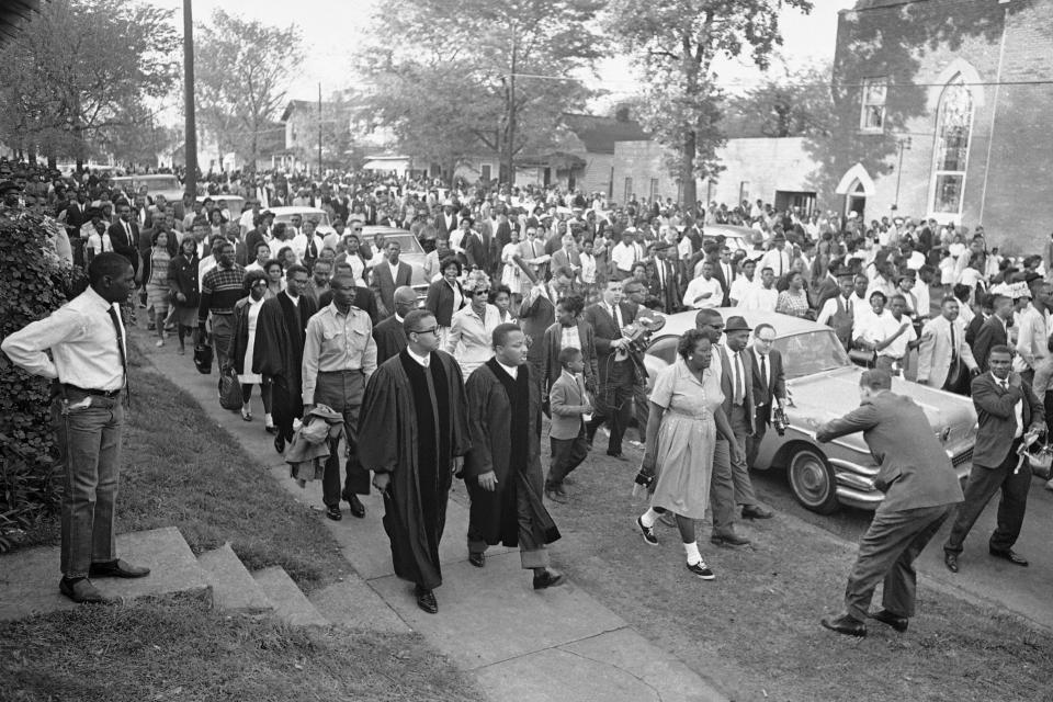 FILE - In this April 14, 1963 file photo, two ministers lead protest marchers in a civil rights demonstration in Birmingham, Ala., which was later broken up by police. The U.S. civil rights movement of the 1950s and 1960s achieved monumental changes over a 15-year period, including landmark federal laws. Yet racism and discrimination remain pervasive problems in 2020. (AP Photo/Horace Cort)