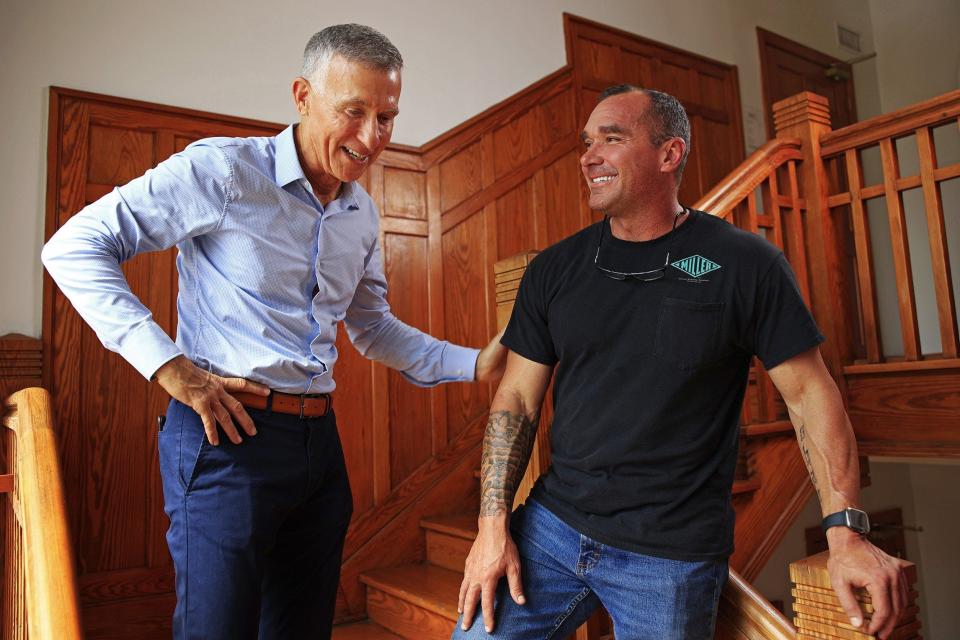 At Operation New Hope in Jacksonville, founder and CEO Kevin Gay (left) meets Aaron Hill, a success story of the nonprofit that provides support, life and job skills training for people with a history of involvement with the criminal justice system.