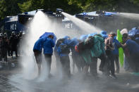 <p>Police uses a water canon while demonstrators block a street during protests against the G-20 summit in Hamburg, Germany, Friday, July 7, 2017. (Photo: Daniel Reinhardt/dpa via AP) </p>