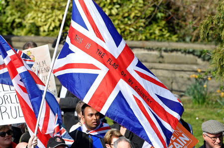 Union Jack flags are waved by Pro-Brexit protesters, as they take part in the March to Leave demonstration, in London, Britain March 29, 2019. REUTERS/Toby Melville