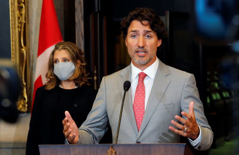 Canadian Prime Minister Trudeau speaks to reporters next to Canadian Deputy Prime Minister and Finance Minister Freeland on Parliament Hill in Ottawa
