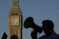 A protestor with a megaphone shouts slogans in front of Big Ben as nurses of the nearby St. Thomas' Hospital protest in London, Monday, Feb. 6, 2023. Tens of thousands of nurses and ambulance staff walked off the job in the U.K. Monday in what unions called the biggest strike in the history of Britain’s public health system. (AP Photo/Frank Augstein)