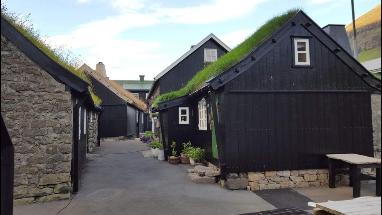 black tiny homes in a small alley