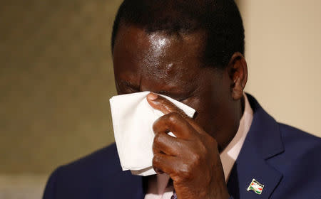Kenya's opposition party leader, Raila Odinga, wipes his face as he prepares for an interview with journalists in London, Britain October 13, 2017. REUTERS/Peter Nicholls