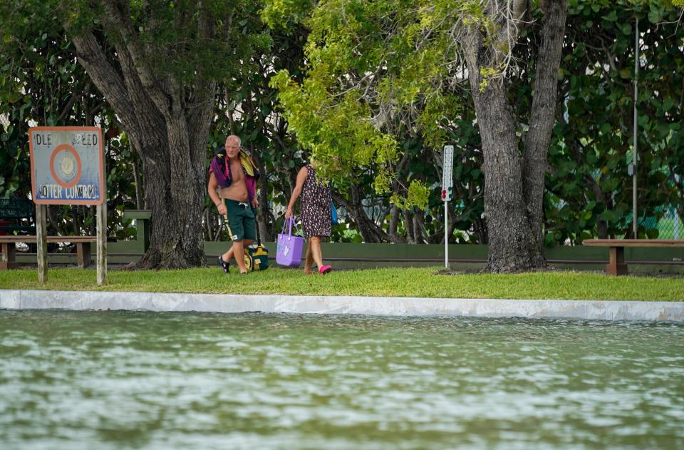 People look at the Vanderbilt Channel as Hurricane Idalia passes Naples during a king tide on Tuesday, Aug. 29, 2023.