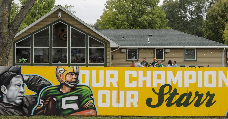 A new fence mural painted by local Green Bay artists Zane Statz and Spencer Young honors Bart Starr on Sept. 15, 2019, on Lombardi Avenue across from Lambeau Field in Green Bay.