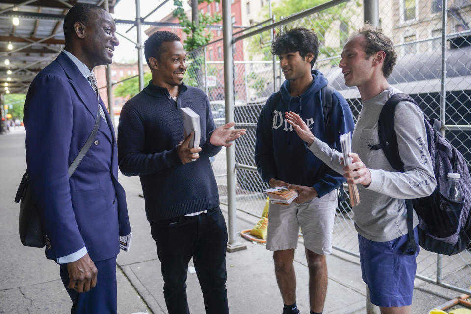 New York City Council candidate Yusef Salaam, left, and his campaign manager Jordan Wright, second from left, talk to campaign volunteers while canvasing in Harlem, Wednesday, May 24, 2023, in New York. Salaam is one of three candidates in a competitive June 27 Democratic primary. With early voting already begun, he faces two seasoned political veterans: New York Assembly members Al Taylor, 65, and Inez Dickens, 73, who previously represented Harlem on the City Council. (AP Photo/Mary Altaffer)