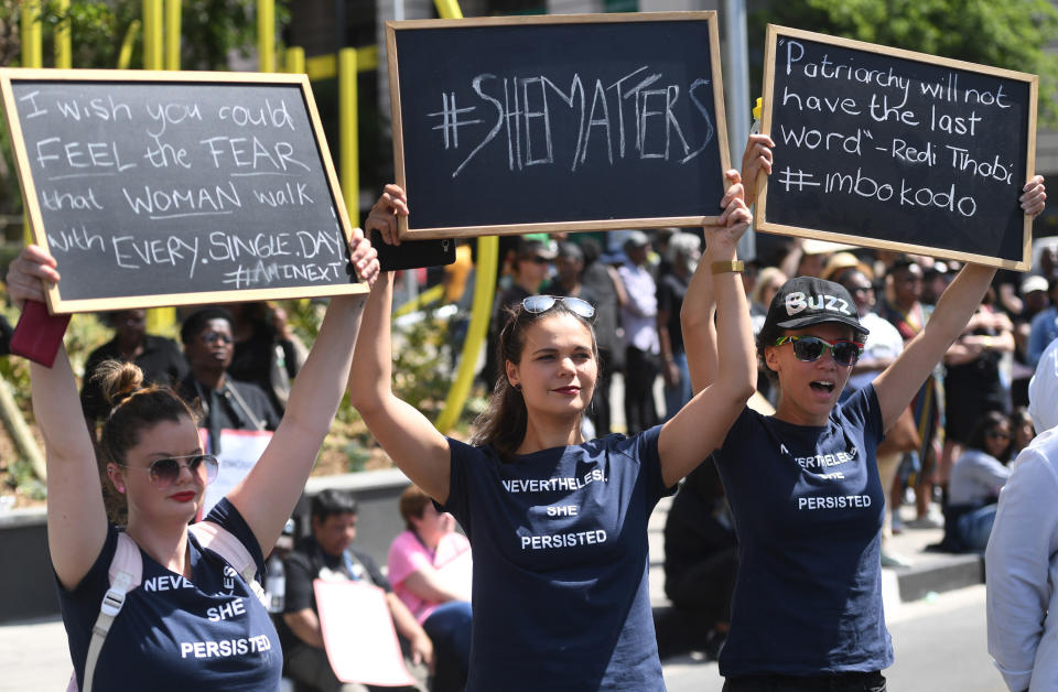 Demonstrators hold up banners as they protest against gender based violence in Sandton, Johannesburg Friday, Sept. 13, 2019. The protesters are calling on President Cyril Ramaphosa to declare a state of emergency, a day after the country's latest crime statistics were released. (AP Photo)