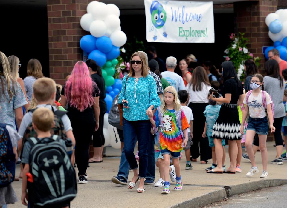 Parents and child arrive for the first day of school at Edmondson Elementary School on Friday, August 6, 2021 in Brentwood, Tenn. 