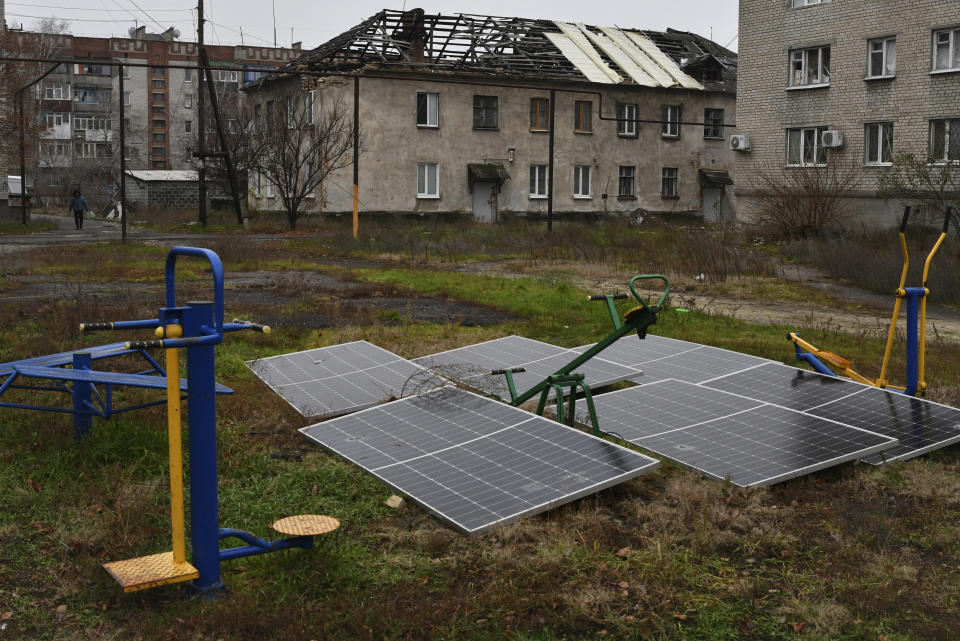 Solar panels seen in the yard of an apartment building in Lyman, Donetsk region, Ukraine, Sunday, Nov. 20, 2022. The situation in Ukraine's capital, Kyiv, and other major cities has deteriorated drastically following the largest missile attack on the country's power grid on Tuesday, Nov. 15, 2022. Ukrainian state-owned grid operator Ukrenergo reported that 40% of Ukrainians were experiencing difficulties, due to damage to at least 15 major energy hubs across the country. (AP Photo/Andriy Andriyenko)