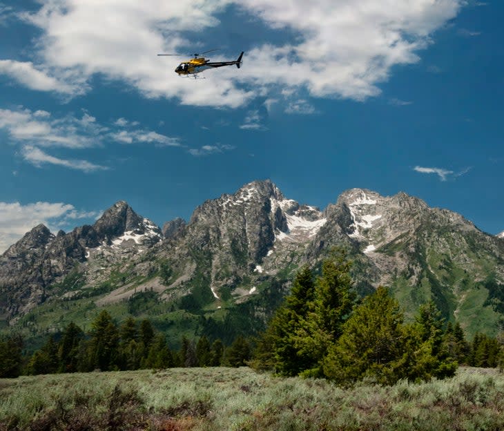 <span class="article__caption">A rescue helicopter flies over the Tetons. </span> (Photo: barbaraaaa / iStock / Getty Images Plus via Getty Images)