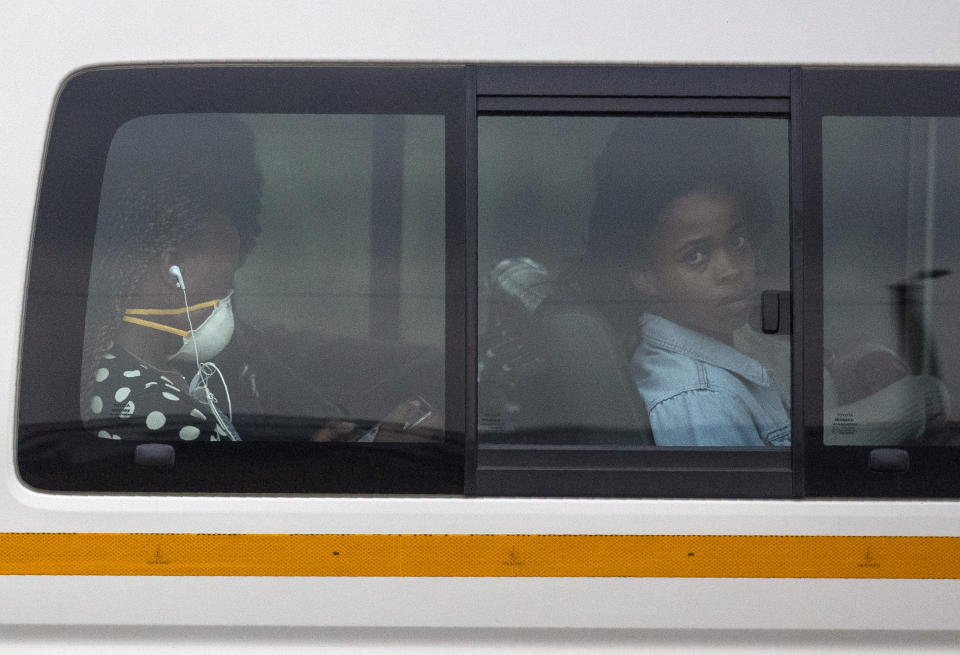 Passengers sits inside a minibus taxi during their journey to home in Kwa-Thema east of Johannesburg, South Africa, Tuesday, March 17, 2020. President Cyril Ramaphosa said all schools will be closed for 30 days from Wednesday and he banned all public gatherings of more than 100 people. South Africa will close 35 of its 53 land borders and will intensify screening at its international airports. For most people, the new COVID-19 coronavirus causes only mild or moderate symptoms. For some it can cause more severe illness. (AP Photo/Themba Hadebe)