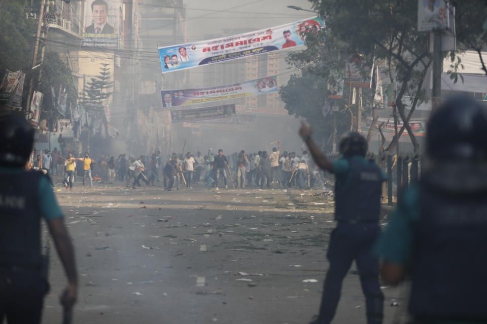 Activists of the Bangladesh Nationalist Party face police during in a protest in Dhaka, Bangladesh, Saturday, Oct. 28, 2023. Police in Bangladesh's capital fired tear gas to disperse supporters of the main opposition party who threw stones at security officials during a rally demanding the resignation of Prime Minister Sheikh Hasina and the transfer of power to a non-partisan caretaker government to oversee general elections next year. (AP Photo/Mahmud Hossain Opu)