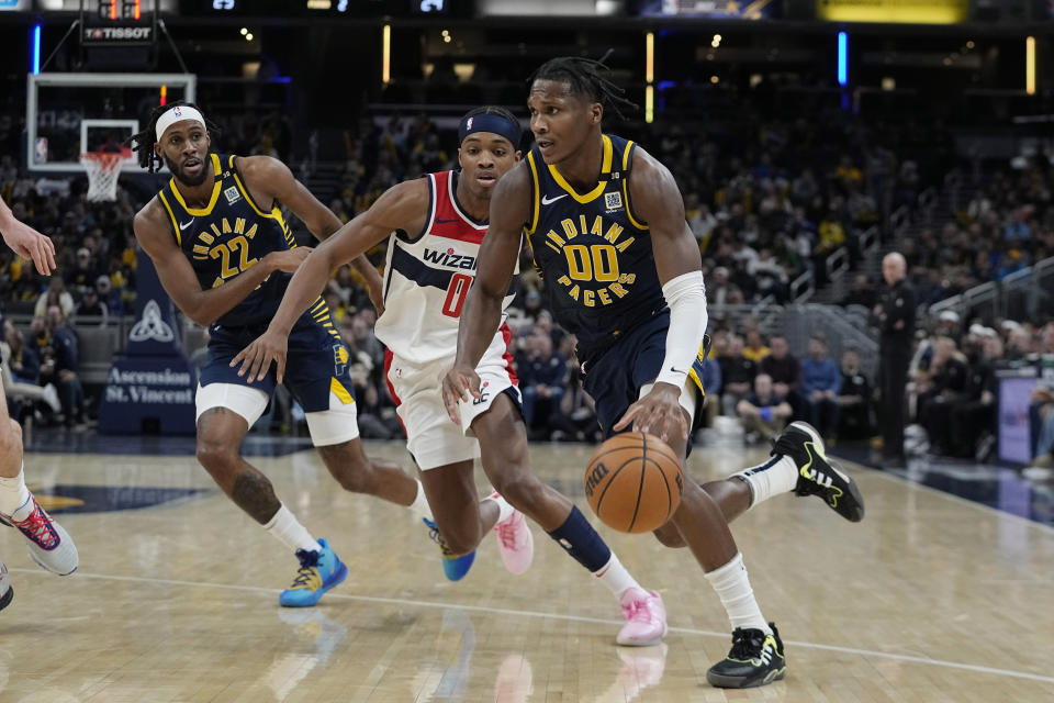 Indiana Pacers' Bennedict Mathurin (00) goes to the basket against Washington Wizards' Bilal Coulibaly (0) during the first half of an NBA basketball game Wednesday, Jan. 10, 2024, in Indianapolis. (AP Photo/Darron Cummings)